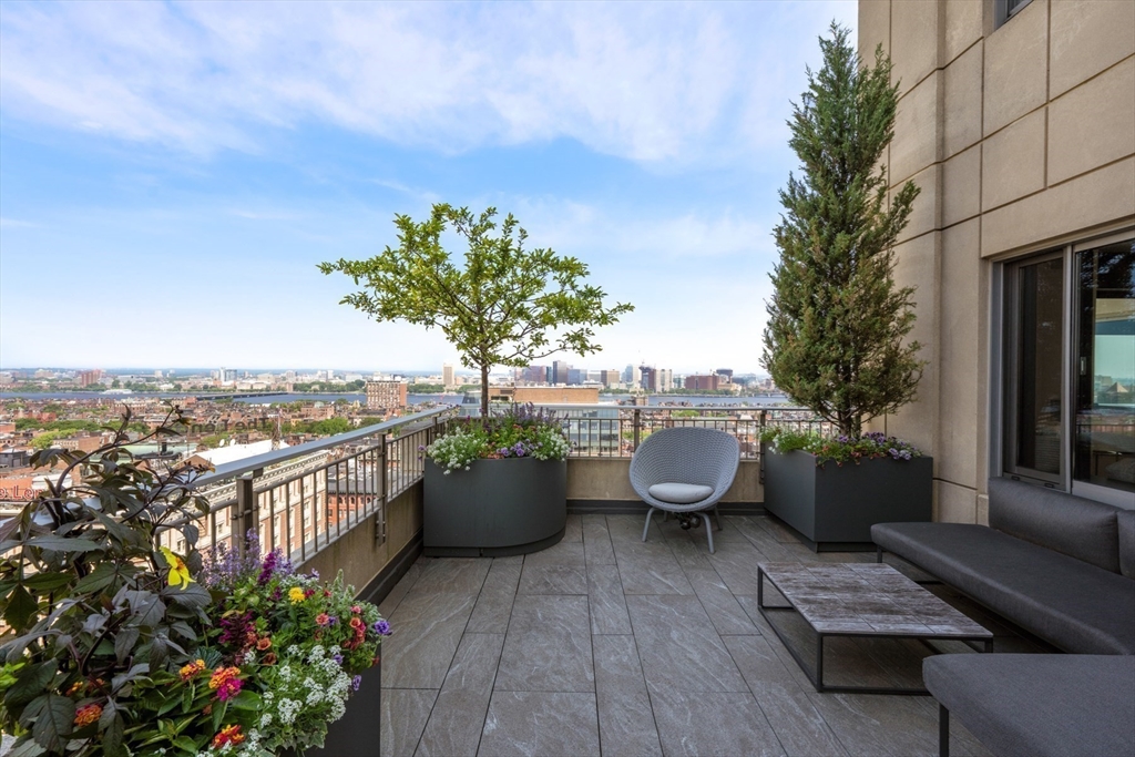 1 Huntington Avenue, Unit 1702 Boston, MA 02116 - Photo 2 of 42 a view of a roof deck with couches and potted plants