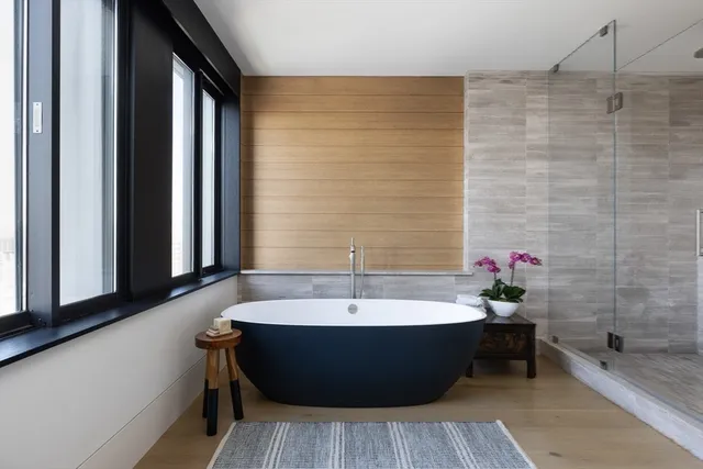 a bathroom with a bathtub and shower