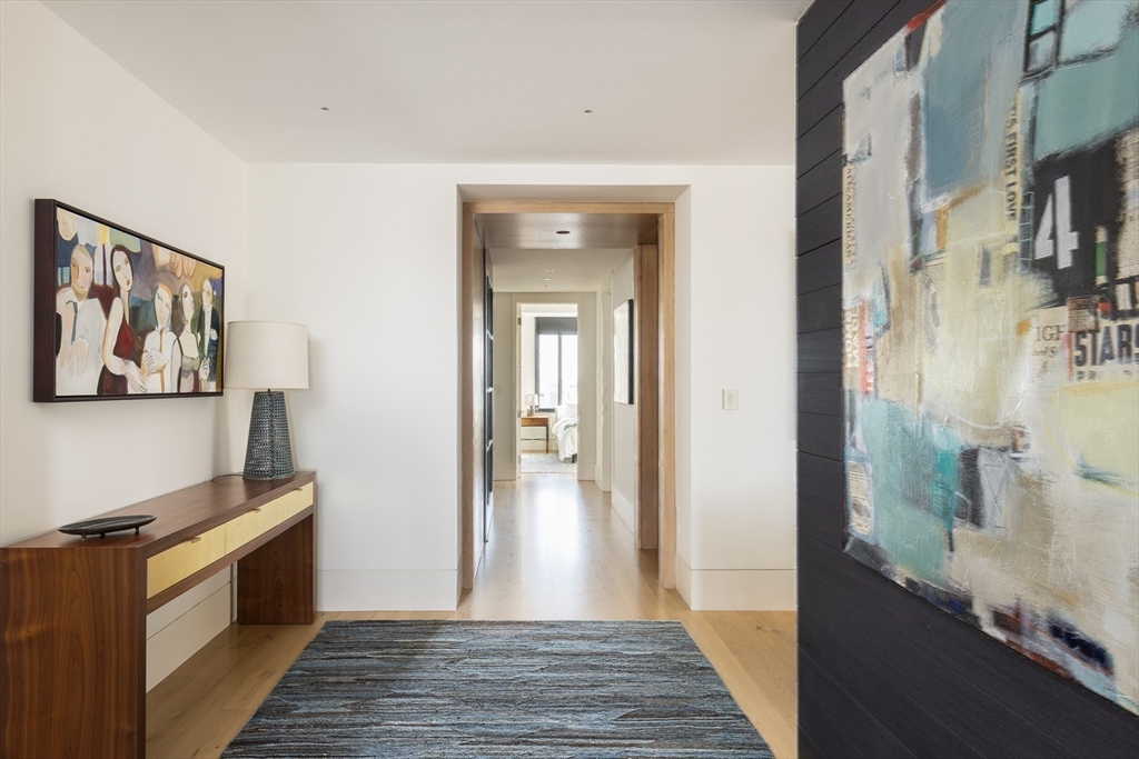 1 Huntington Avenue, Unit 1702 Boston, MA 02116 - Photo 29 of 42 a view of a hallway with wooden floor and staircase