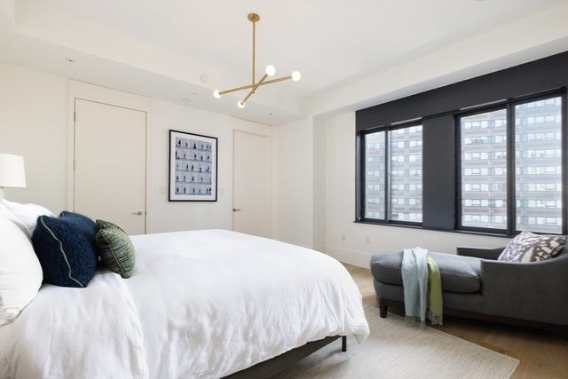 a bedroom with a bed couch and window