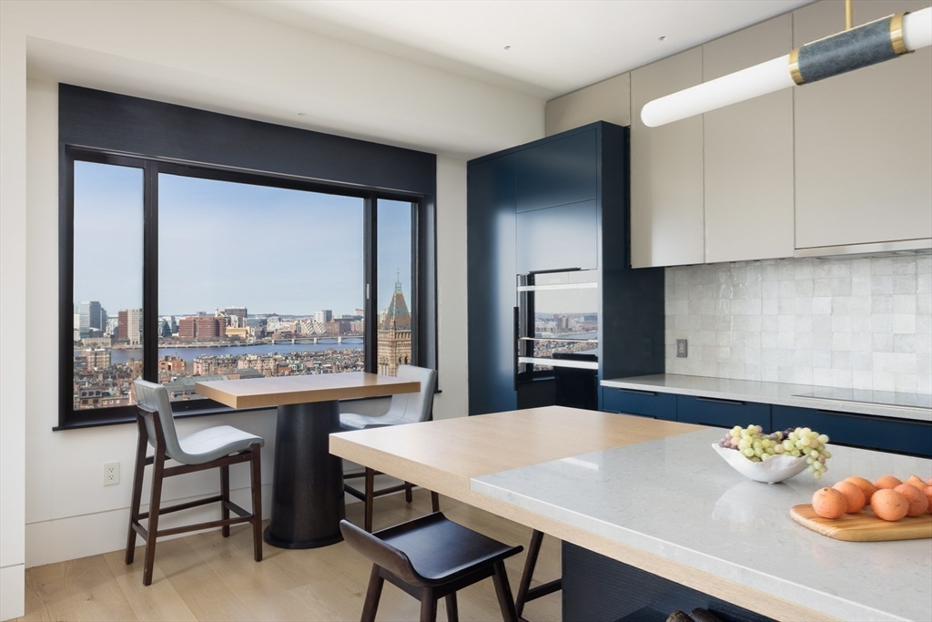 1 Huntington Avenue, Unit 1702 Boston, MA 02116 - Photo 5 of 42 a view of a dining room with furniture and a potted plant