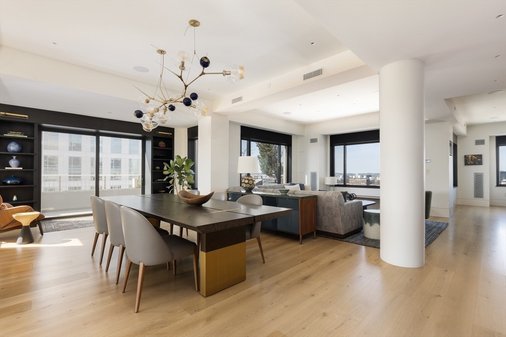 1 Huntington Avenue, Unit 1702 Boston, MA 02116 - Photo 5 of 42 a view of a dining room with furniture and wooden floor
