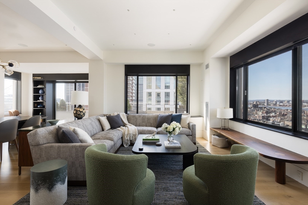1 Huntington Avenue, Unit 1702 Boston, MA 02116 - Photo 10 of 42 a living room with furniture and a large window