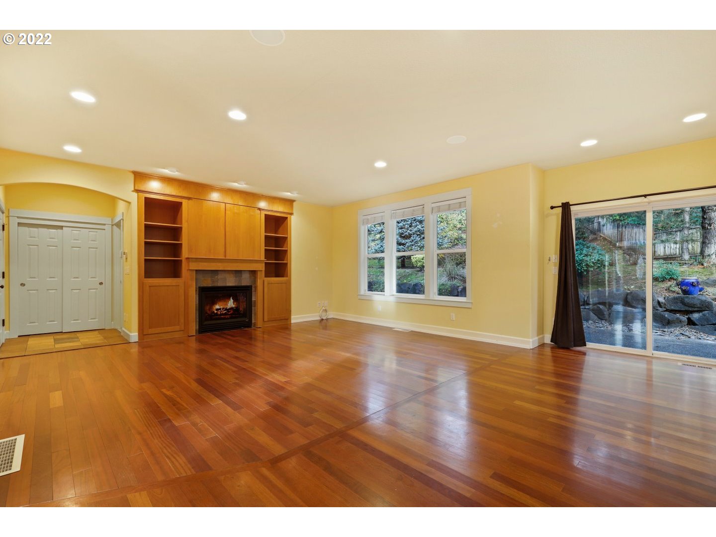 3237 Ridge Pointe Drive Forest Grove, OR 97116 - Photo 11 of 32 a view of empty room with wooden floor and fireplace