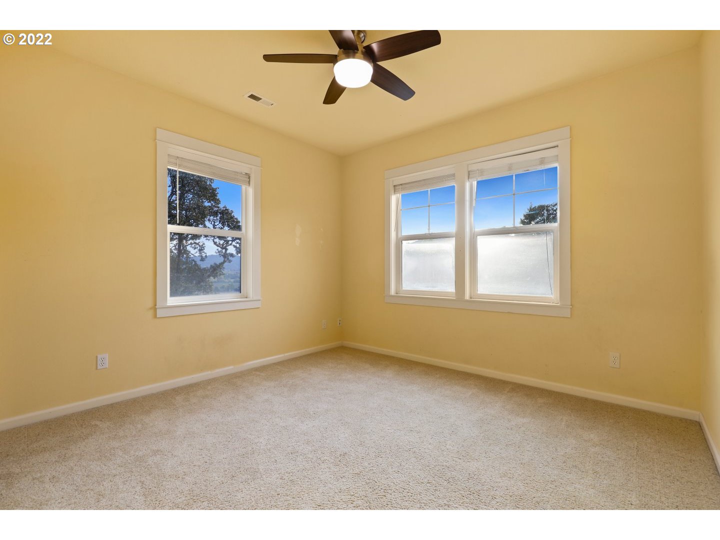 3237 Ridge Pointe Drive Forest Grove, OR 97116 - Photo 23 of 32 a view of an empty room with window and a ceiling fan