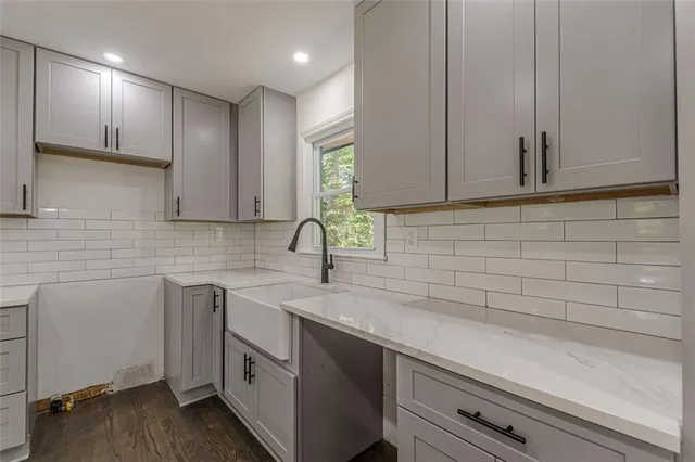a kitchen with a sink and cabinets