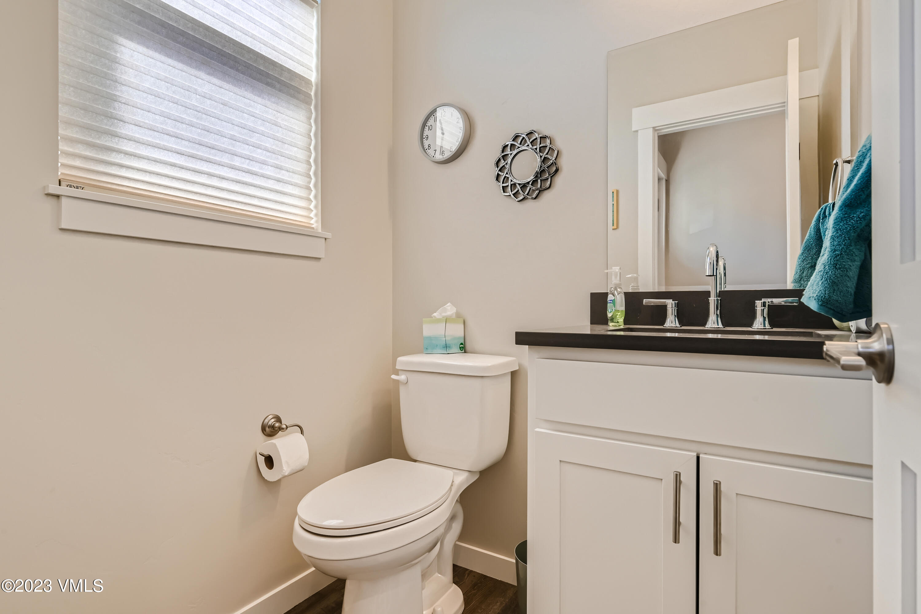604 Chickadee Lane Gypsum, CO 81637 - Photo 4 of 11 a bathroom with a toilet sink and mirror