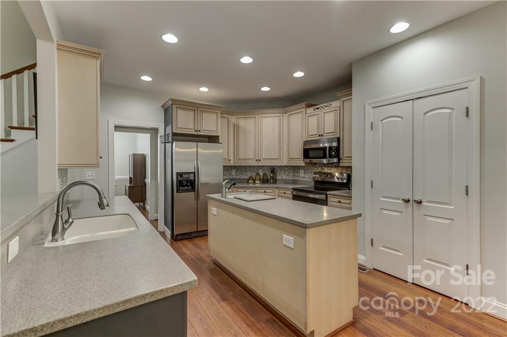11111 Broken Brook Way Tega Cay, SC 29708 - Photo 9 of 46 a kitchen with a refrigerator sink and cabinets