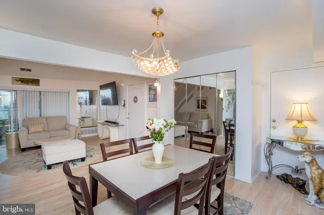 a kitchen with stainless steel appliances a dining table and chairs