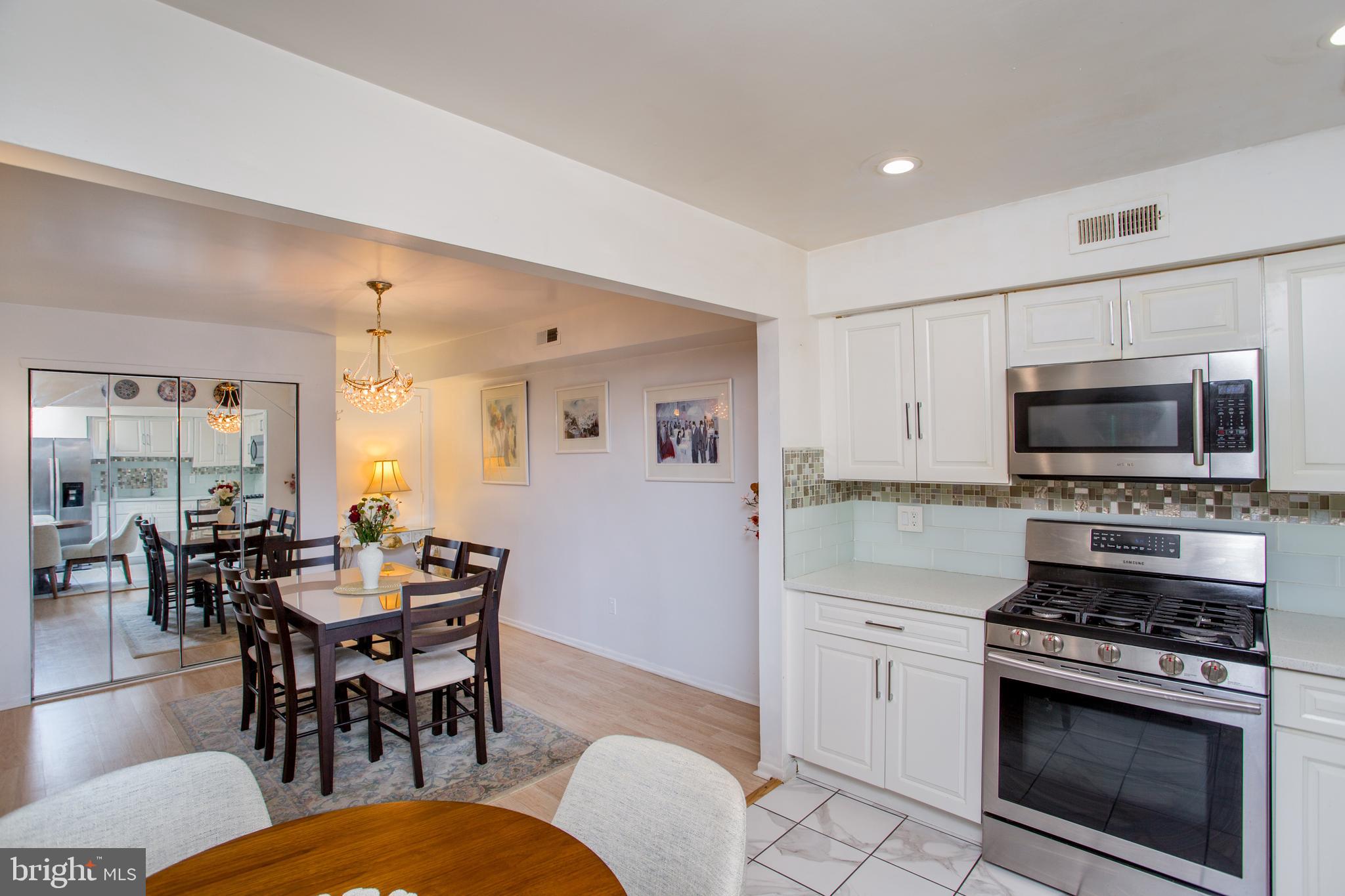 48 Bonnie Gellman Court, Unit B48 Philadelphia, PA 19114 - Photo 16 of 70 a kitchen with stainless steel appliances a dining table and chairs