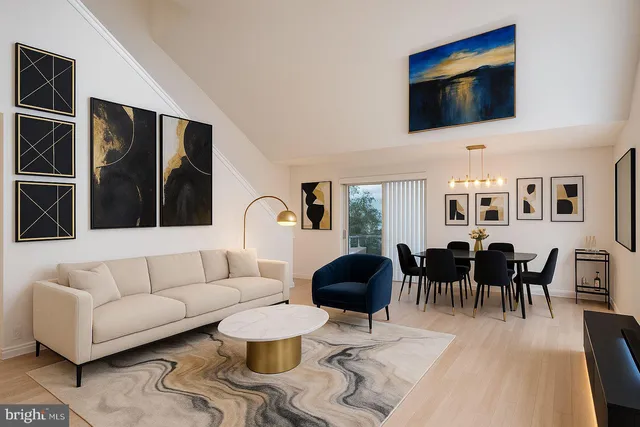 a living room with furniture a rug and a flat screen tv