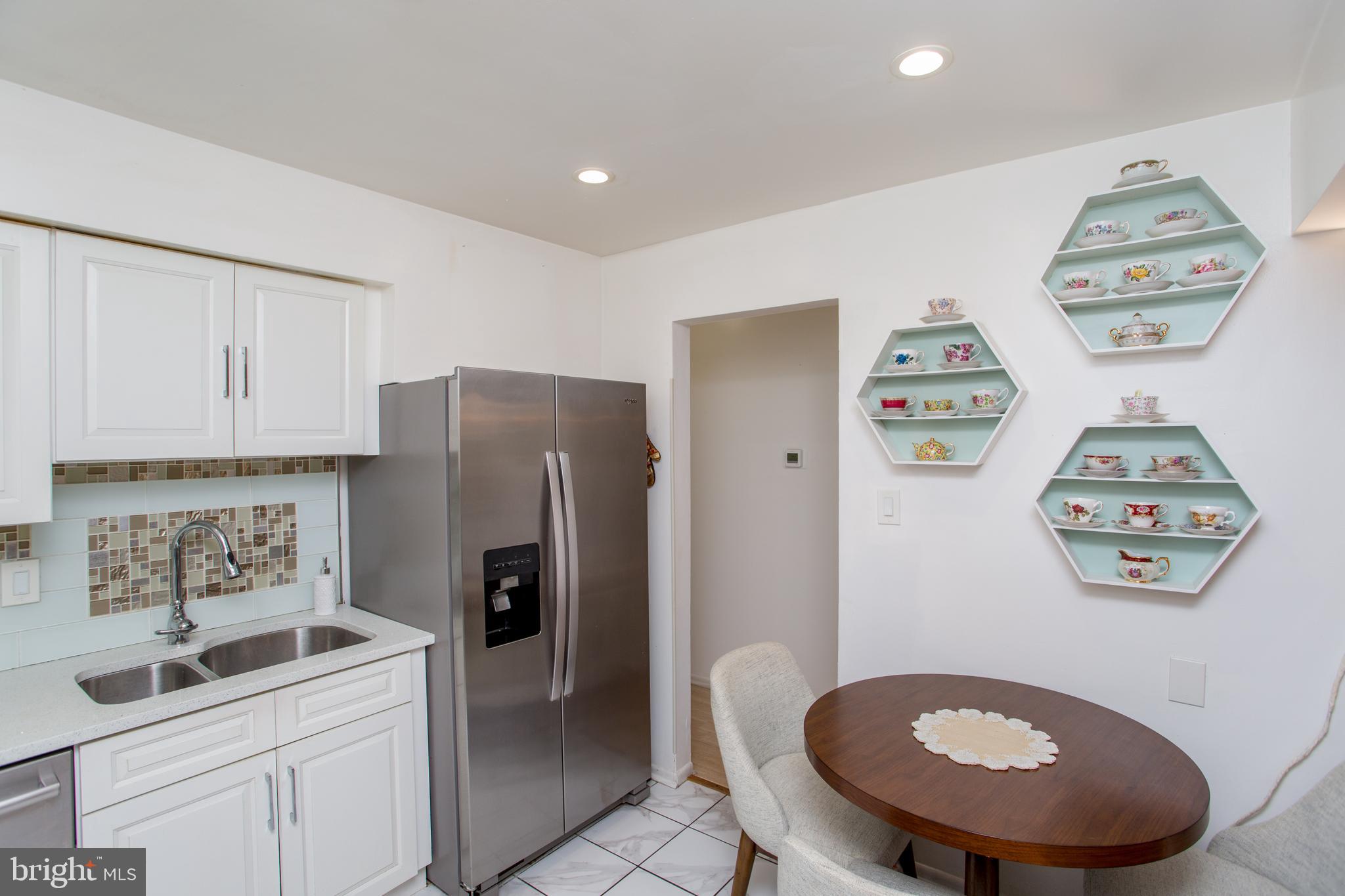 48 Bonnie Gellman Court, Unit B48 Philadelphia, PA 19114 - Photo 21 of 70 a kitchen with stainless steel appliances a refrigerator and a stove