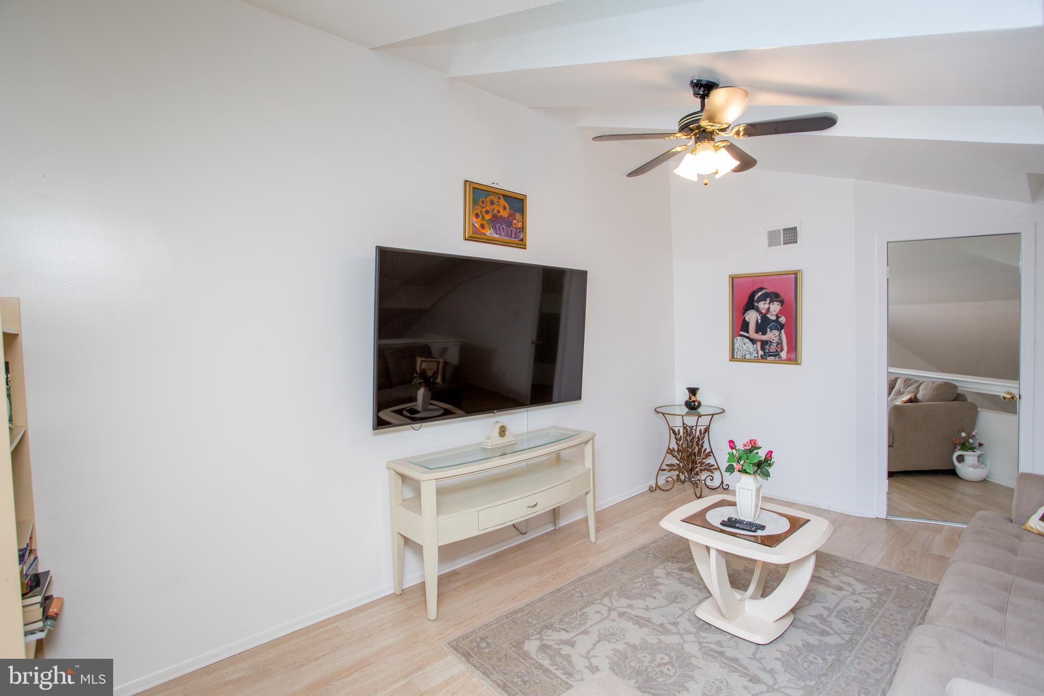 48 Bonnie Gellman Court, Unit B48 Philadelphia, PA 19114 - Photo 26 of 70 a living room with furniture and a flat screen tv