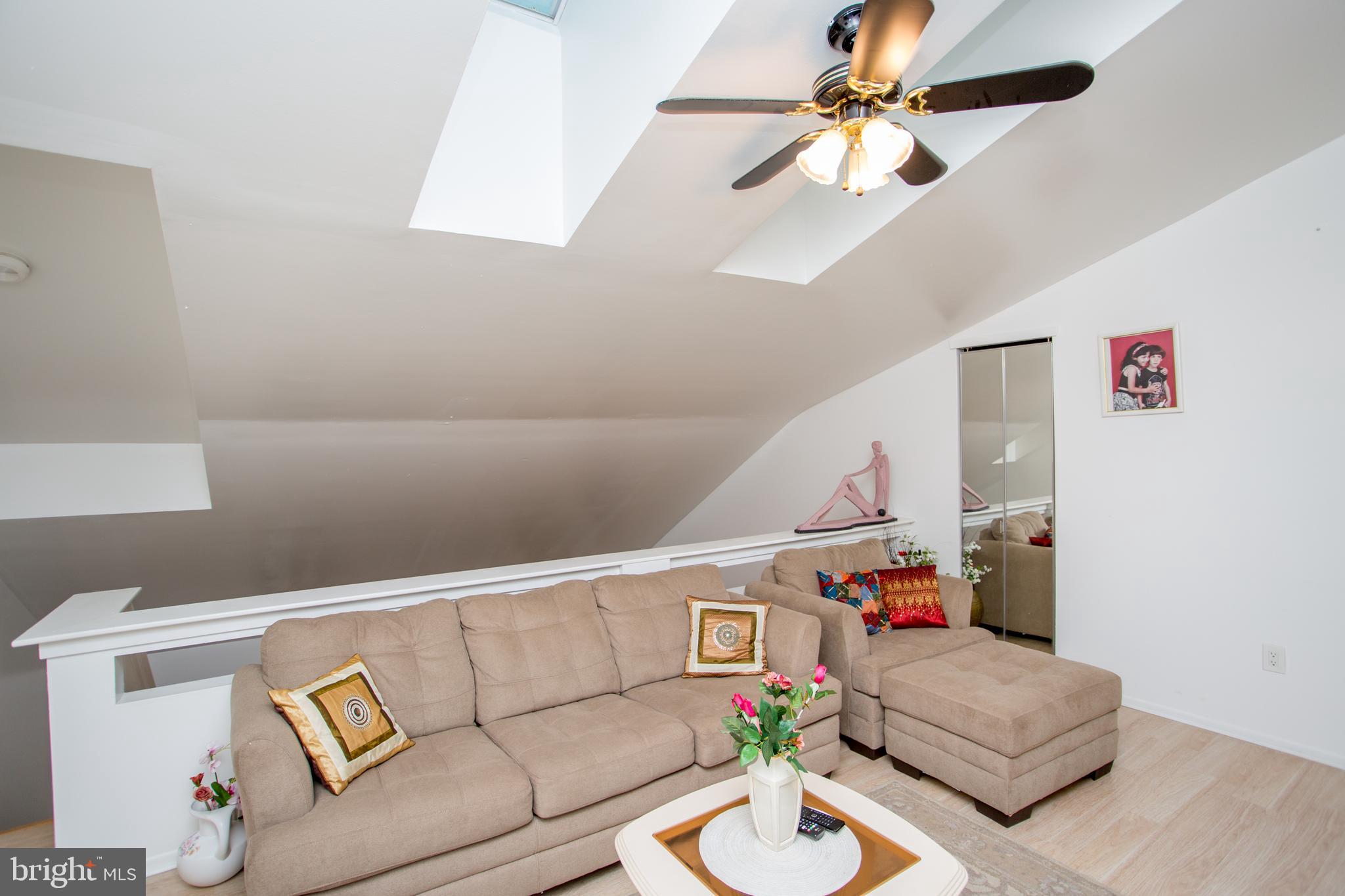 48 Bonnie Gellman Court, Unit B48 Philadelphia, PA 19114 - Photo 29 of 70 a living room with furniture and a chandelier