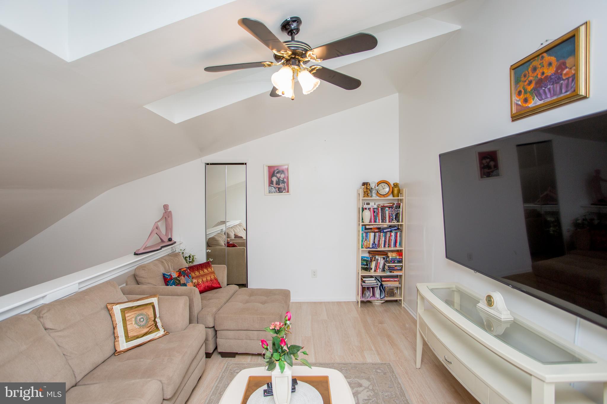 48 Bonnie Gellman Court, Unit B48 Philadelphia, PA 19114 - Photo 30 of 70 a living room with furniture and a flat screen tv