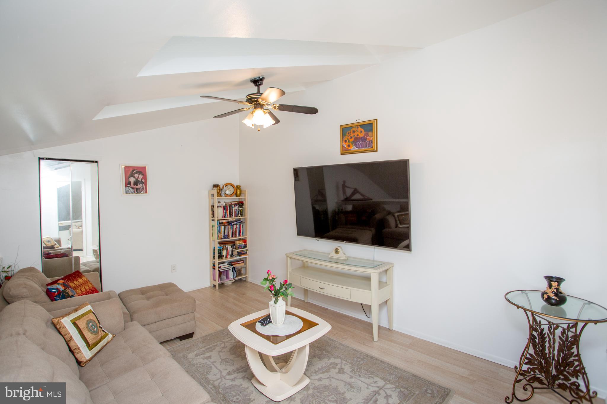 48 Bonnie Gellman Court, Unit B48 Philadelphia, PA 19114 - Photo 31 of 70 a living room with furniture and a flat screen tv