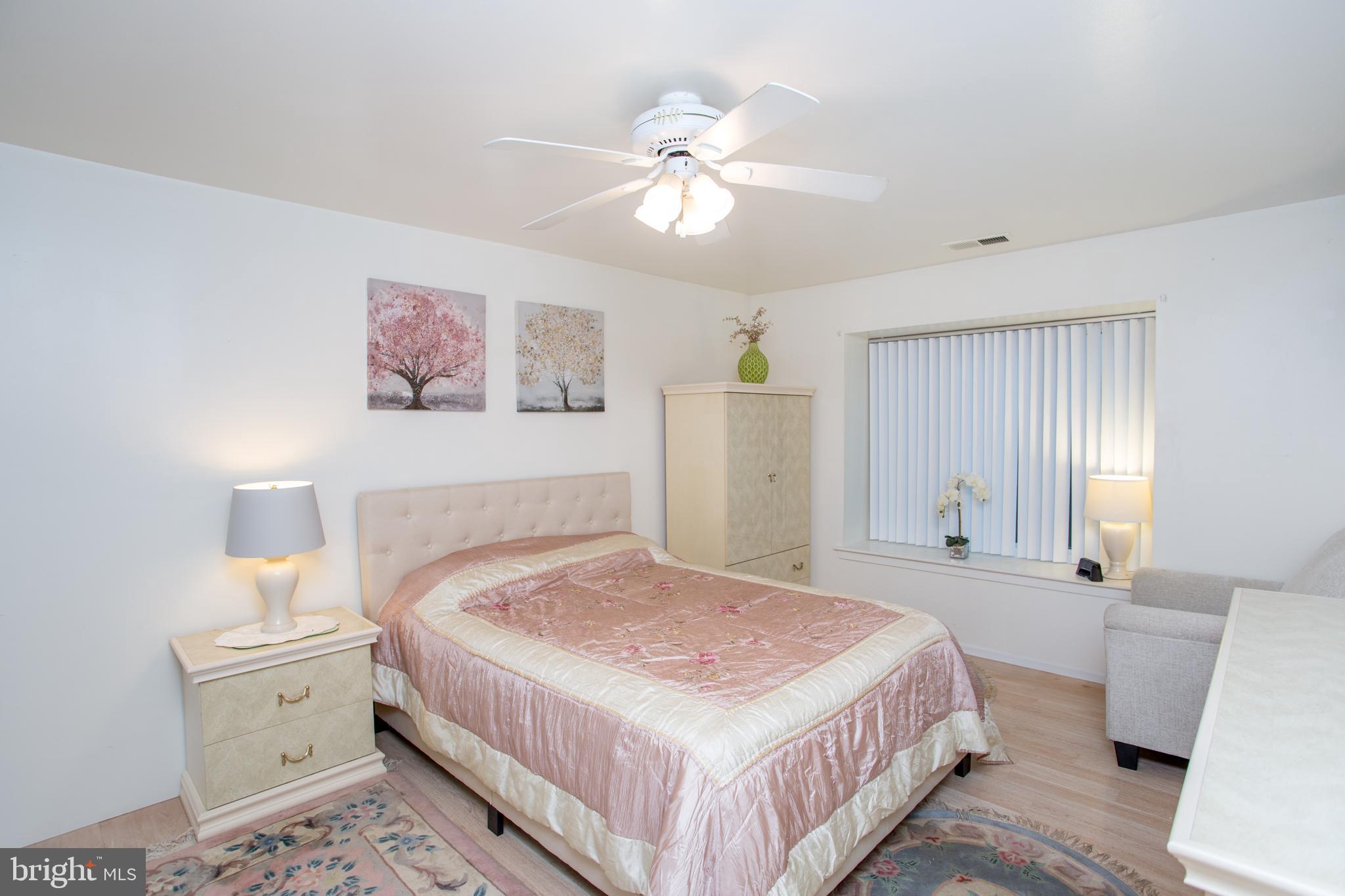 48 Bonnie Gellman Court, Unit B48 Philadelphia, PA 19114 - Photo 32 of 70 a bedroom with a bed and a chandelier