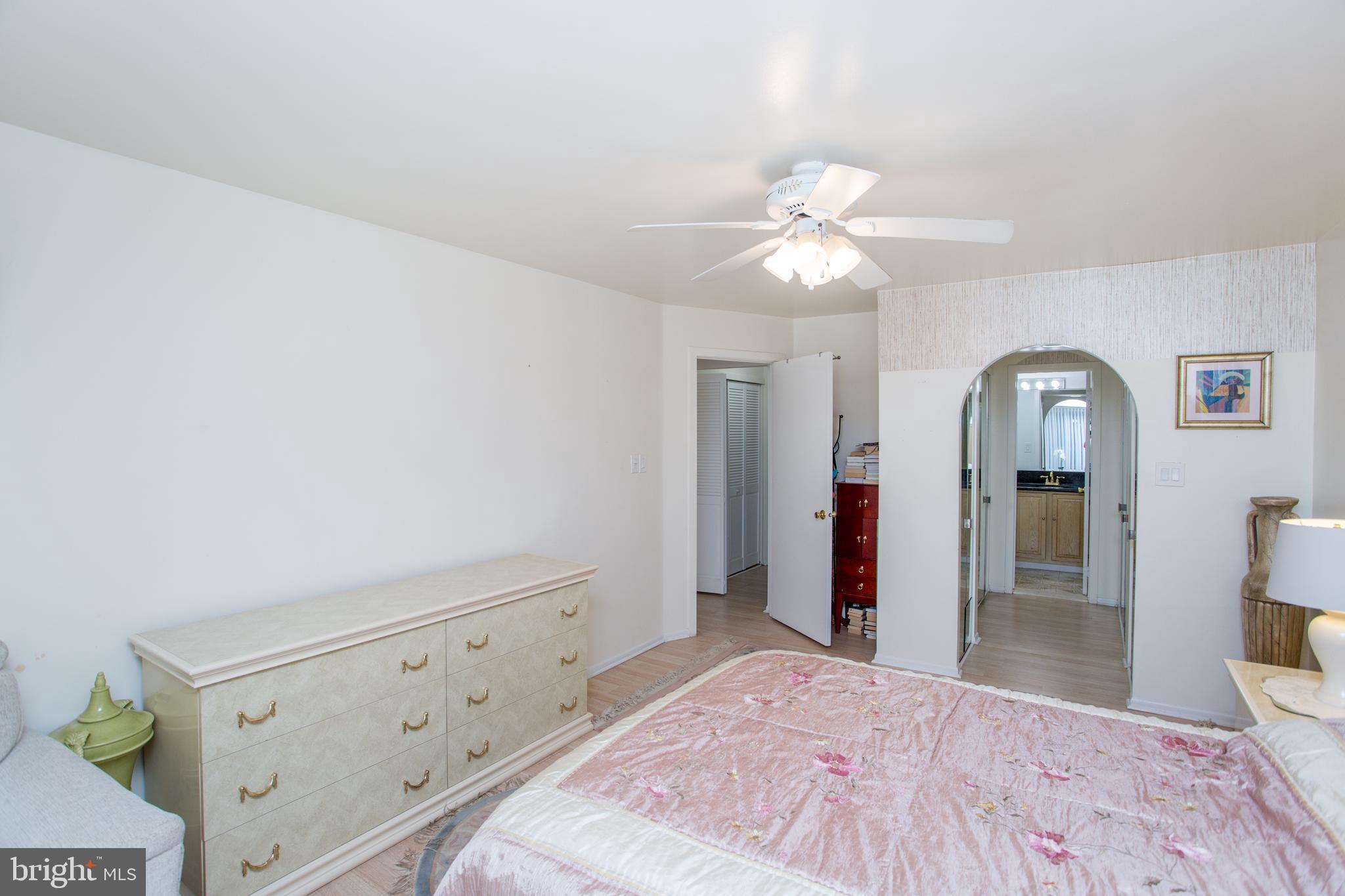 48 Bonnie Gellman Court, Unit B48 Philadelphia, PA 19114 - Photo 35 of 70 a bedroom with a bed and a chandelier