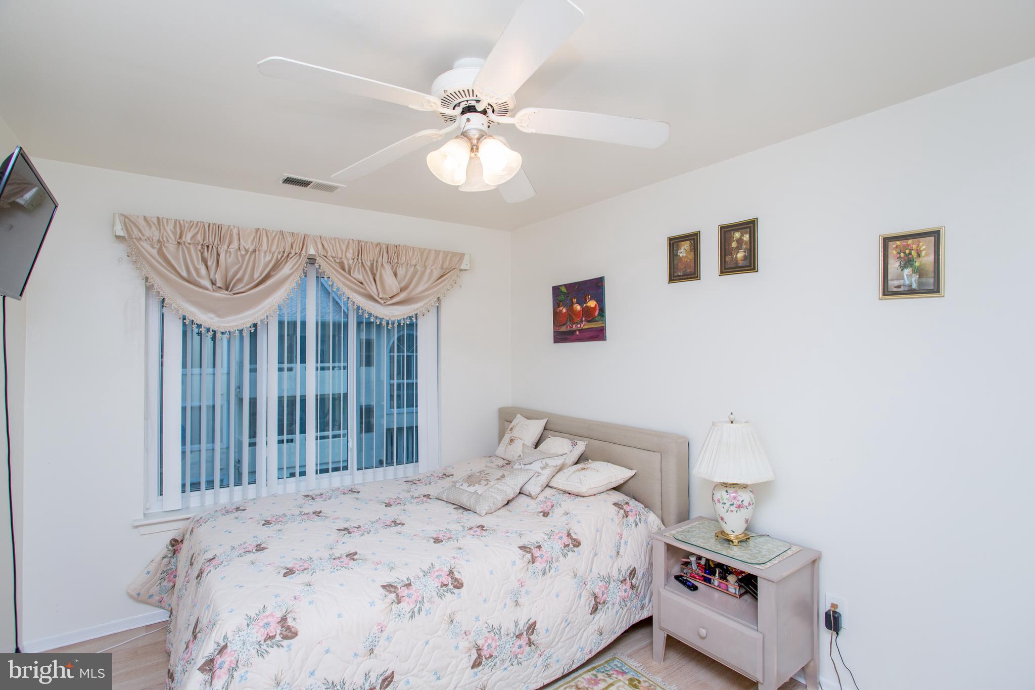 48 Bonnie Gellman Court, Unit B48 Philadelphia, PA 19114 - Photo 40 of 70 a bedroom with a bed and a chandelier