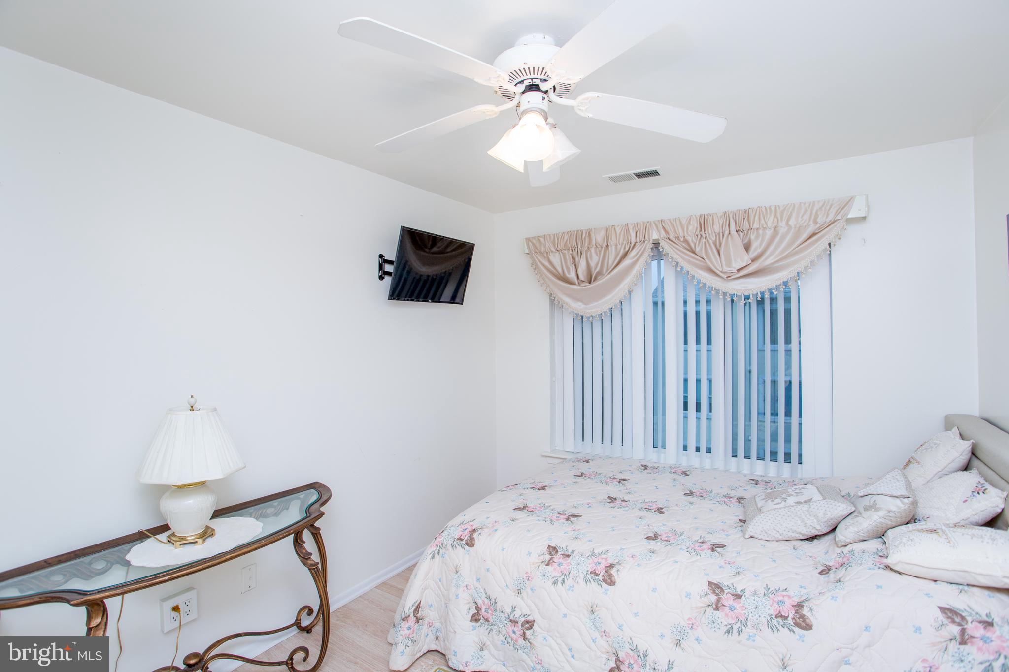 48 Bonnie Gellman Court, Unit B48 Philadelphia, PA 19114 - Photo 41 of 70 a bedroom with a bed and a chandelier