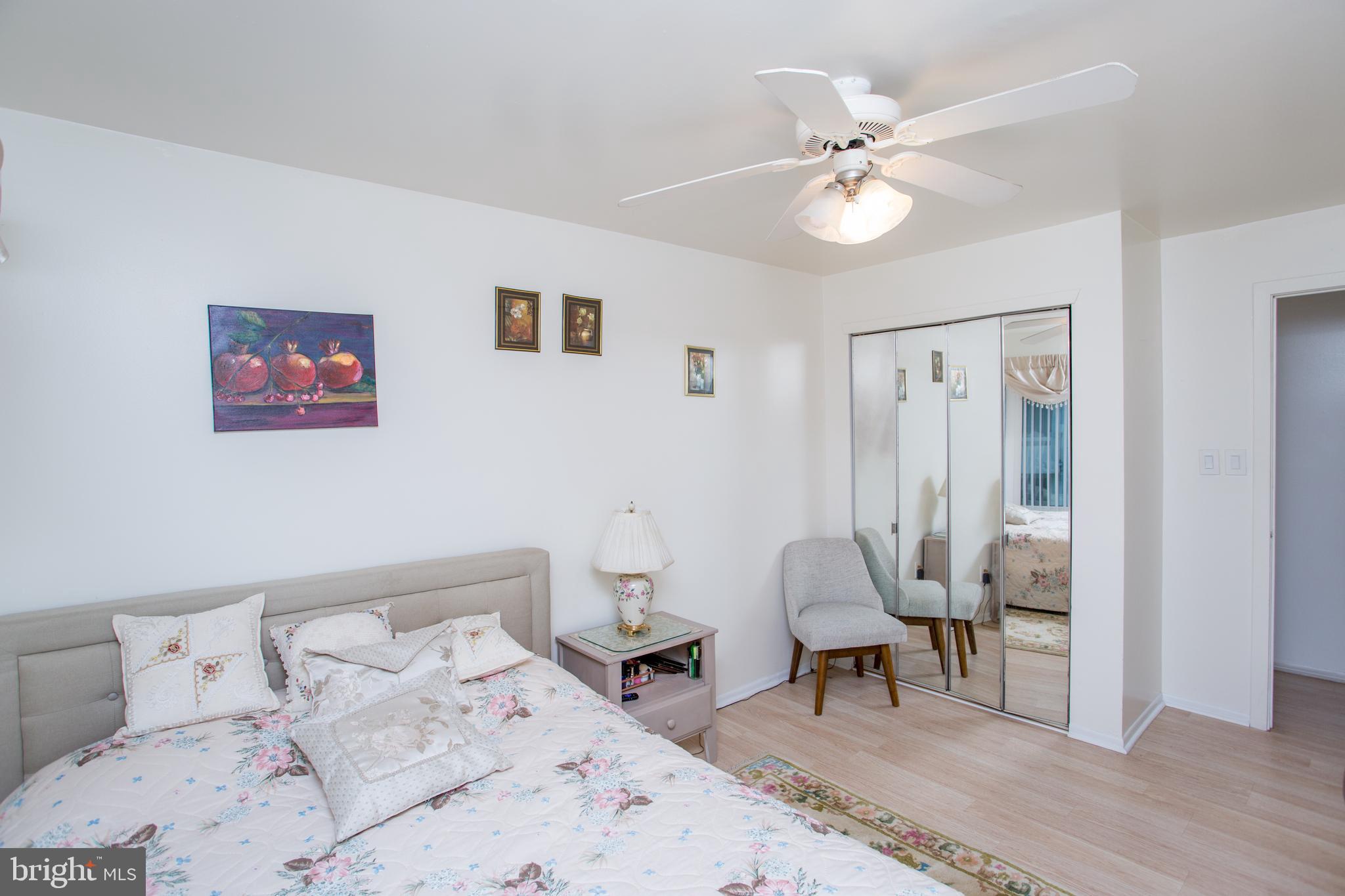 48 Bonnie Gellman Court, Unit B48 Philadelphia, PA 19114 - Photo 42 of 70 a bedroom with a bed and a chandelier