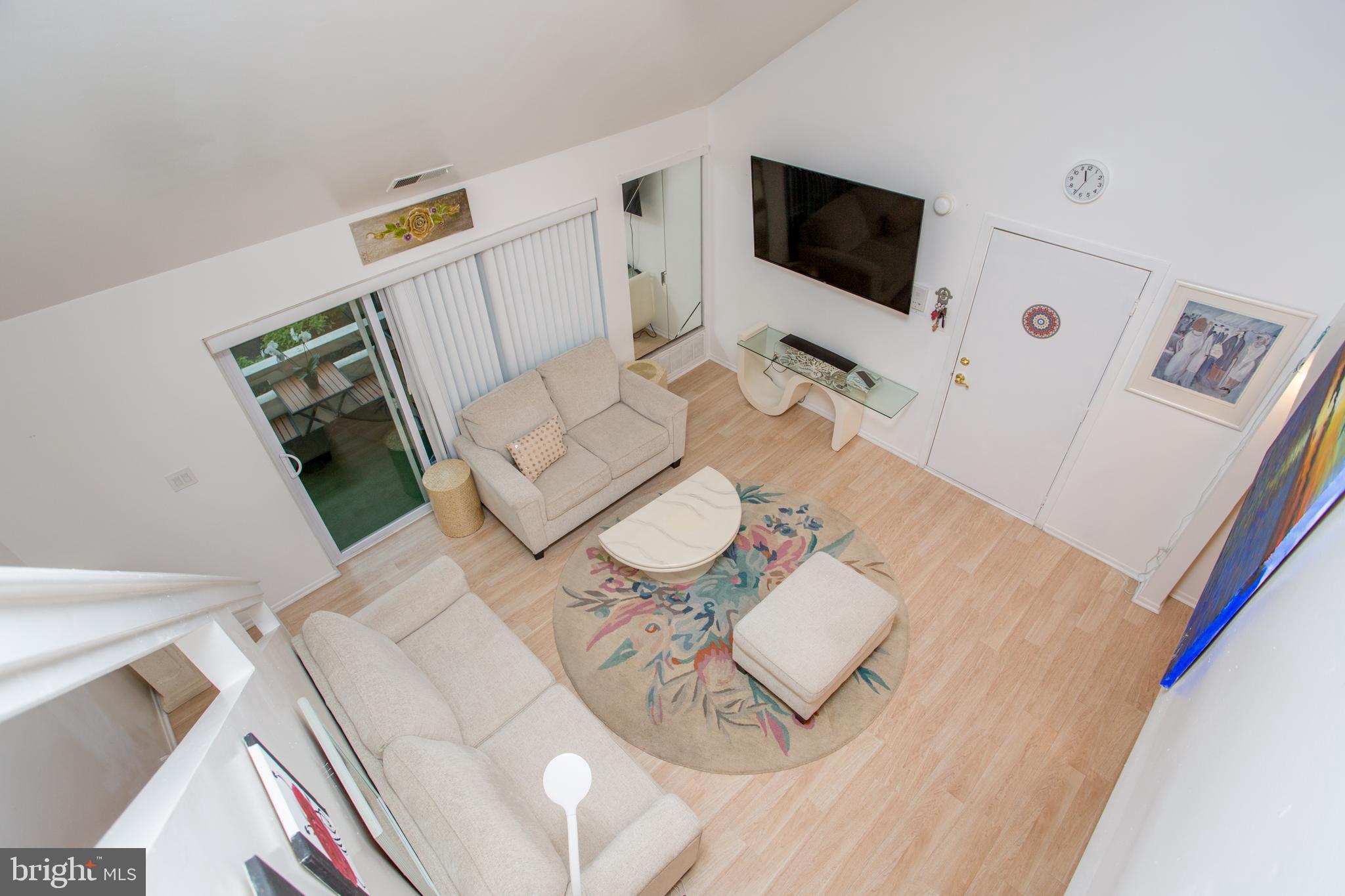 48 Bonnie Gellman Court, Unit B48 Philadelphia, PA 19114 - Photo 9 of 70 a living room with furniture and a flat screen tv