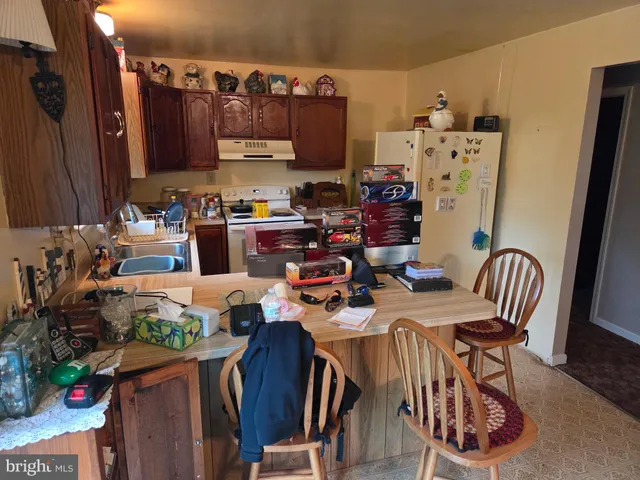 a view of a dining room with furniture a rug and wooden floor
