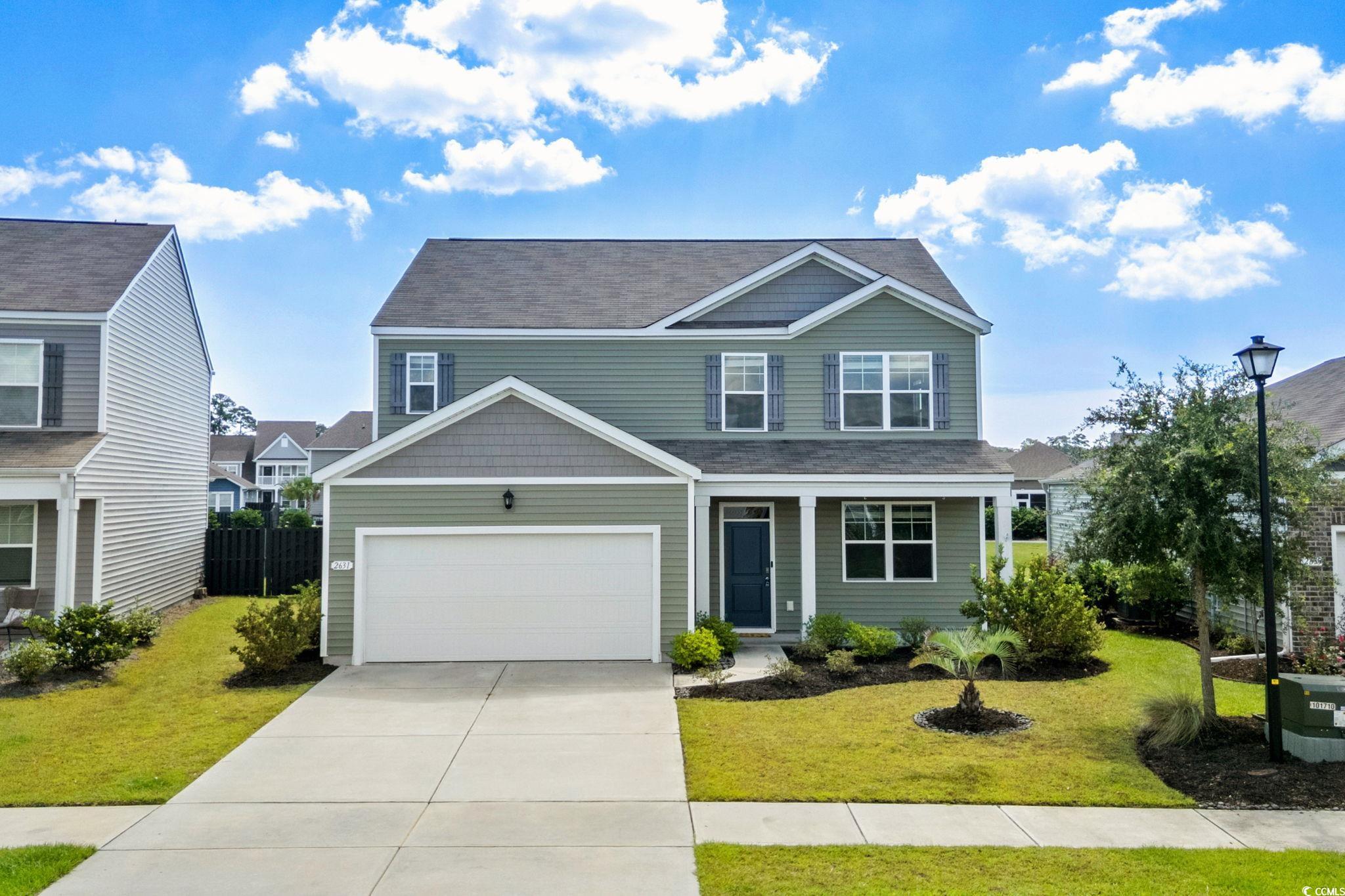 View of front of house featuring covered porch, driveway, a garage, and a shingled roof