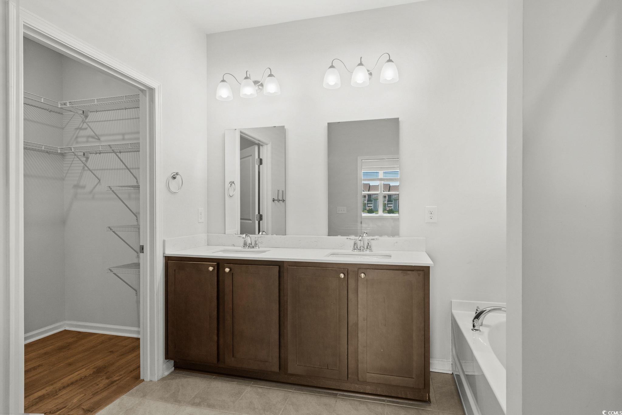 2631 Ophelia Way Myrtle Beach, SC 29577 - Photo 19 of 40 Full bathroom featuring a spacious closet, double vanity, a garden tub, and light tile patterned flooring