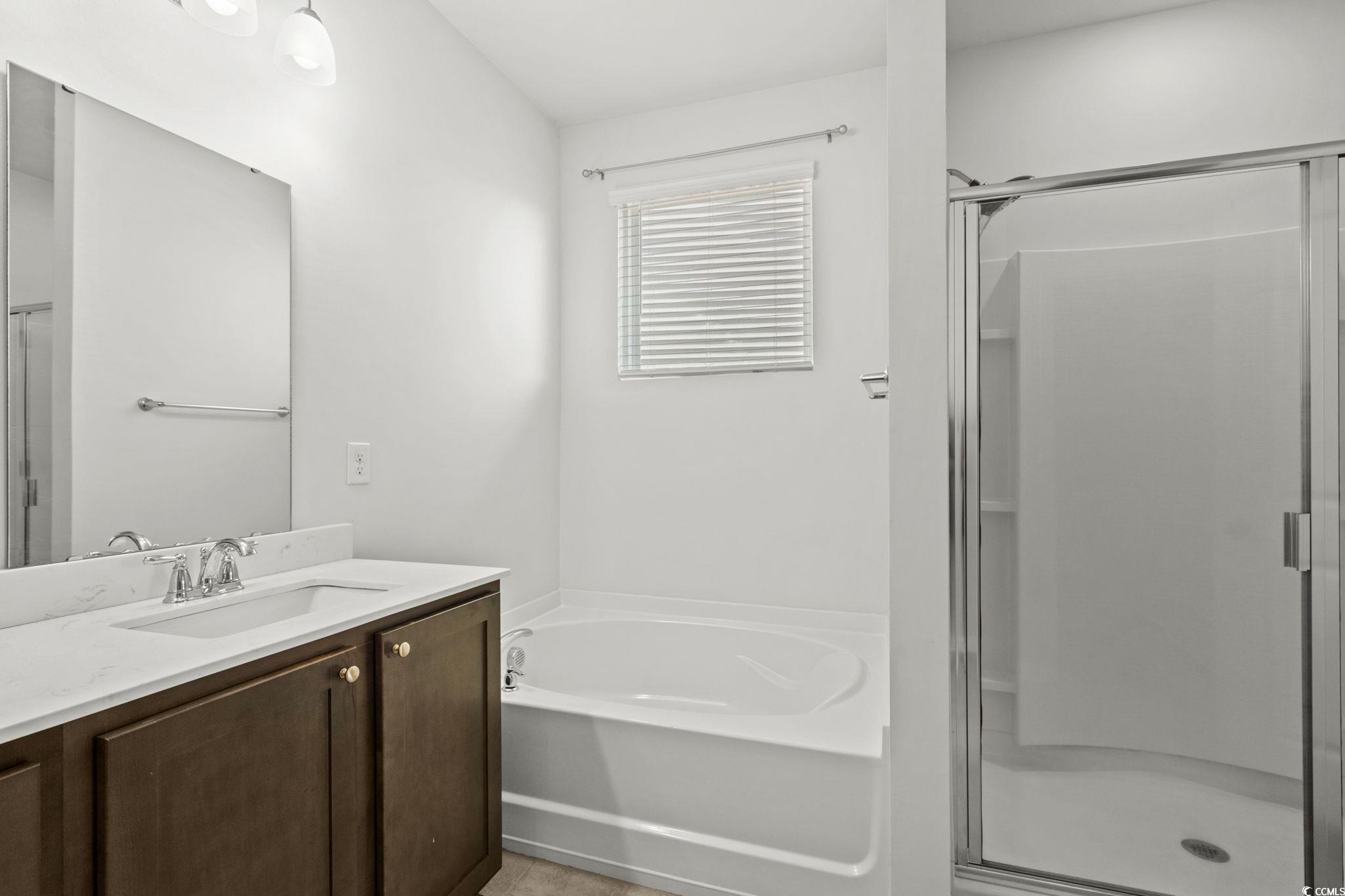 2631 Ophelia Way Myrtle Beach, SC 29577 - Photo 22 of 40 Bathroom featuring vanity, a garden tub, a stall shower, and light tile patterned flooring