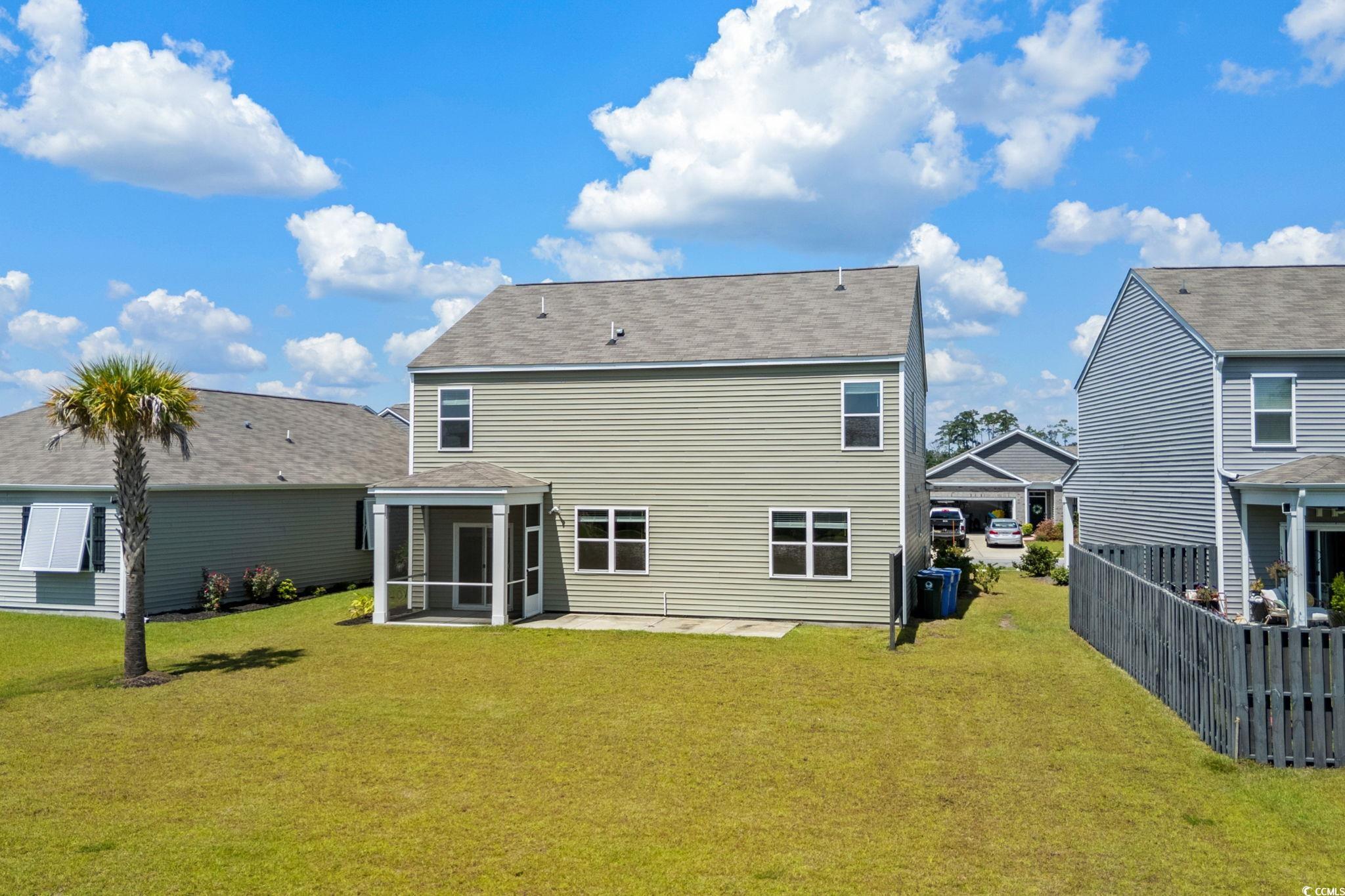 2631 Ophelia Way Myrtle Beach, SC 29577 - Photo 32 of 40 Rear view of property featuring a yard, a patio, and a sunroom