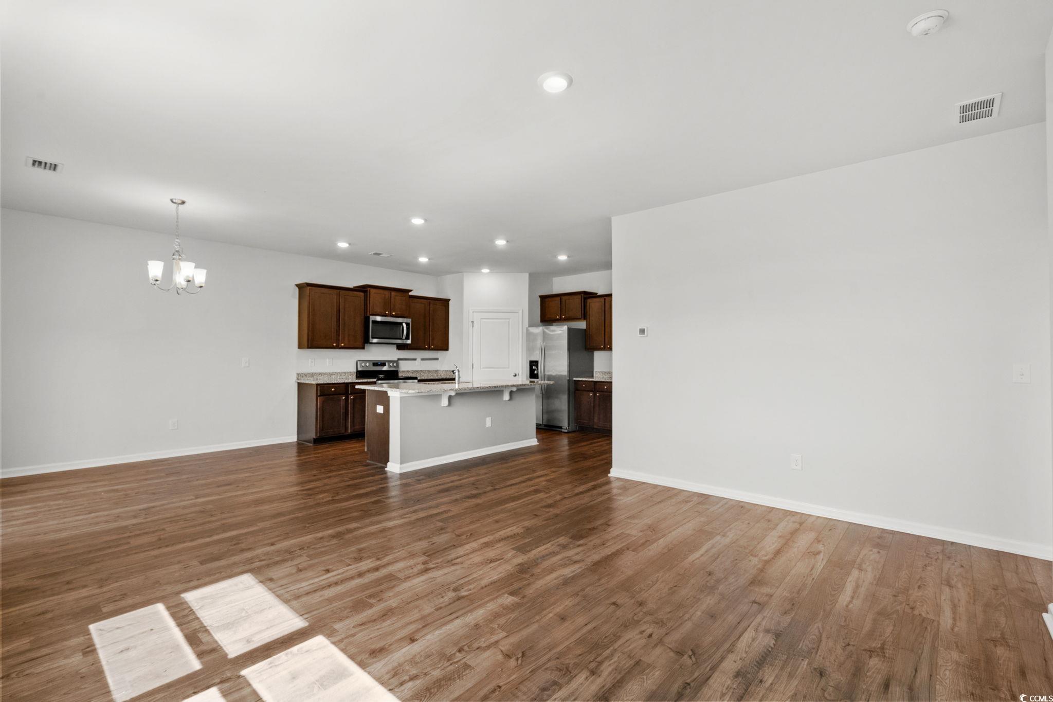 2631 Ophelia Way Myrtle Beach, SC 29577 - Photo 10 of 40 Unfurnished living room featuring a chandelier, recessed lighting, and dark wood finished floors
