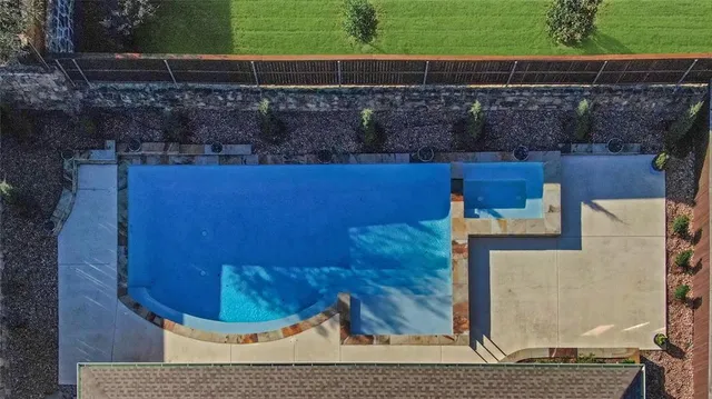 a living room with stainless steel appliances furniture and a flat screen tv