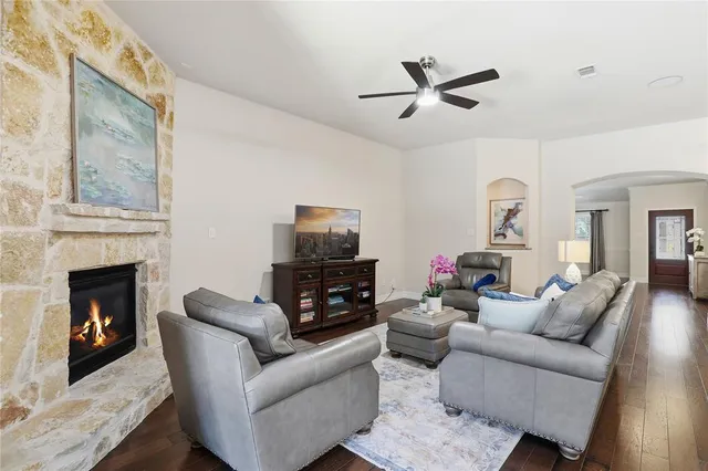 a living room with furniture kitchen view and a chandelier