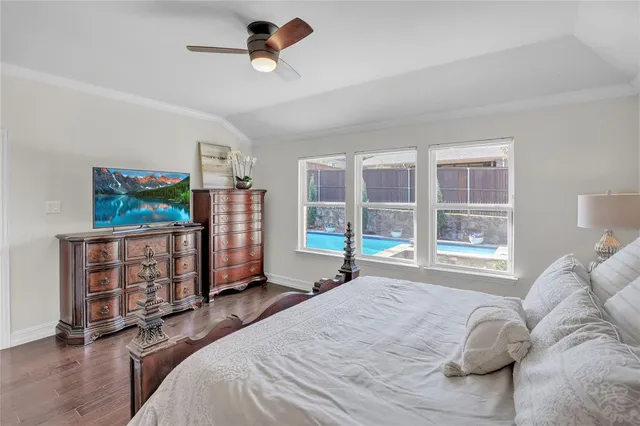 a bedroom with bed and wooden floor