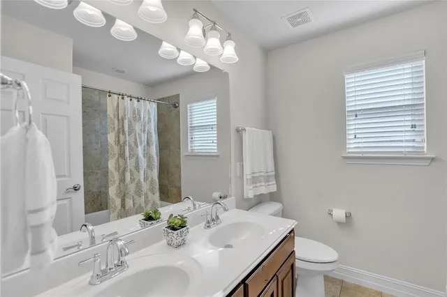 a bathroom with a double vanity sink and a mirror