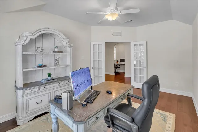 a dining room with wooden floor and a window