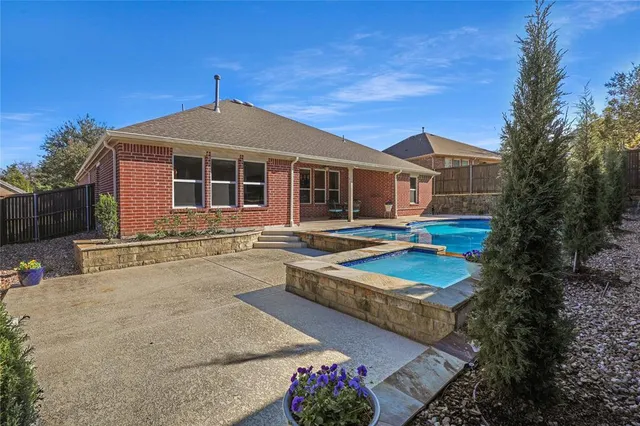 a front view of house with yard and trees in the background