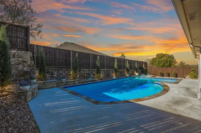 an aerial view of a house with garden space and parking