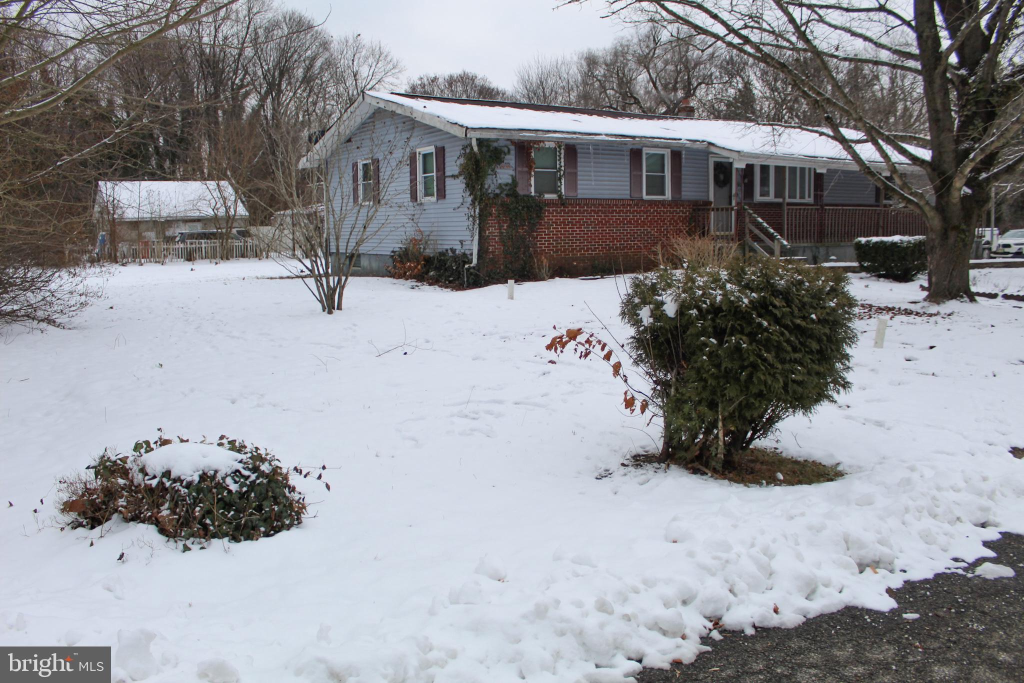 30 Sharp Avenue Bridgeton, NJ 08302 - Photo 3 of 18 a front view of a house with a yard covered in snow