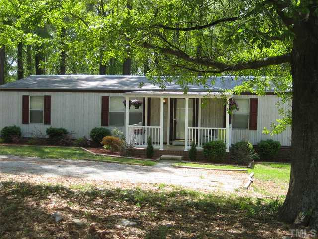 7500 Rock Service Station Road Raleigh, NC 27603 - Photo 21 of 21 Another view of the home with new gravel drive and the great shade trees and beautiful azaleas.