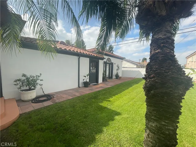 a view of a backyard with potted plants