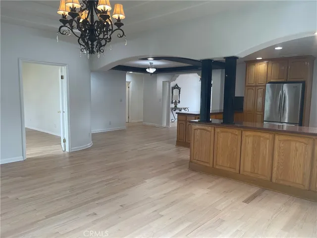 a view of a kitchen with a sink and chandelier