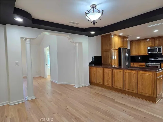 a view of a kitchen with a sink and refrigerator