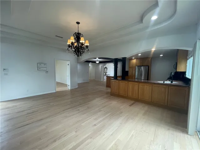 a view of a living room and kitchen with wooden floor