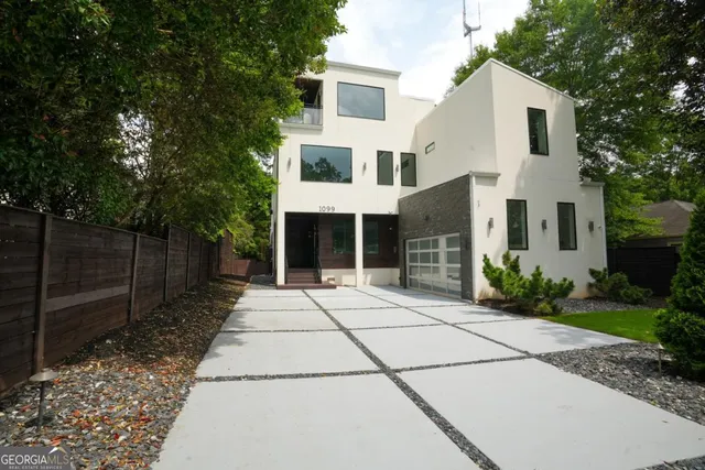 a front view of a house with a garden