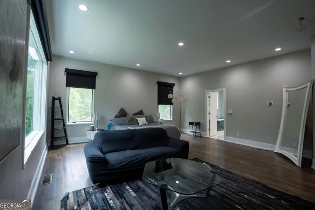 a living room with furniture and a wooden floor
