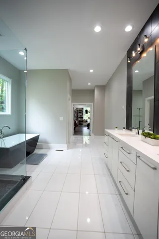 a large white kitchen with a large tub