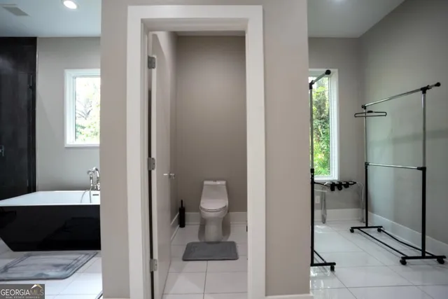 a bathroom with a toilet and a shower
