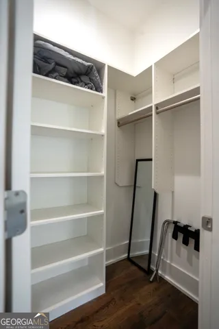 a view of walk in closet with empty racks